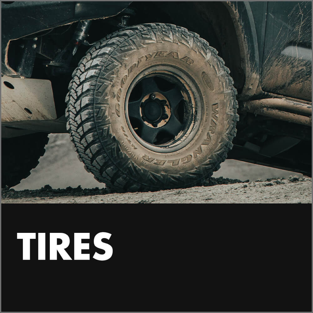 All-terrain tire mounted on a Toyota Tacoma, showcasing rugged tread design for off-road capability