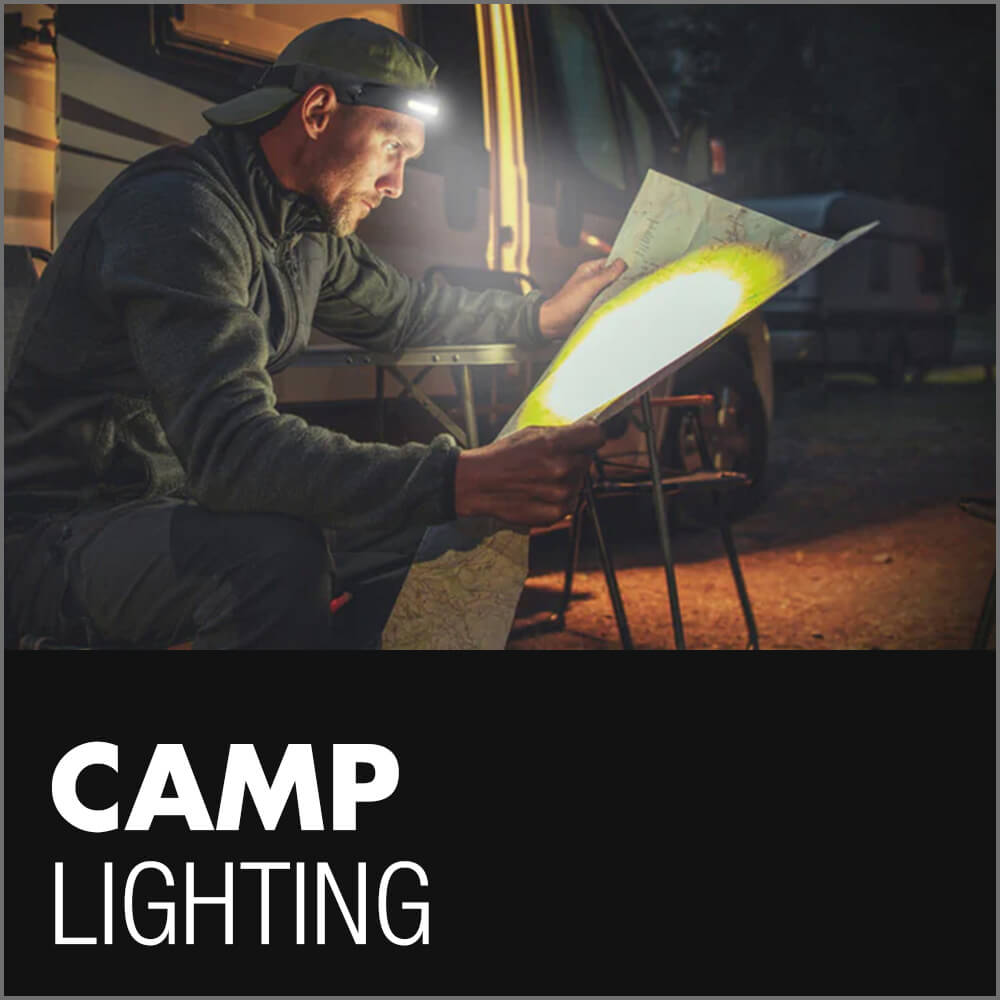 Man seated at a campsite illuminated by bright LED camping lights, with the caption Camp Lighting emphasizing outdoor illumination solutions for Toyota Tacoma owners